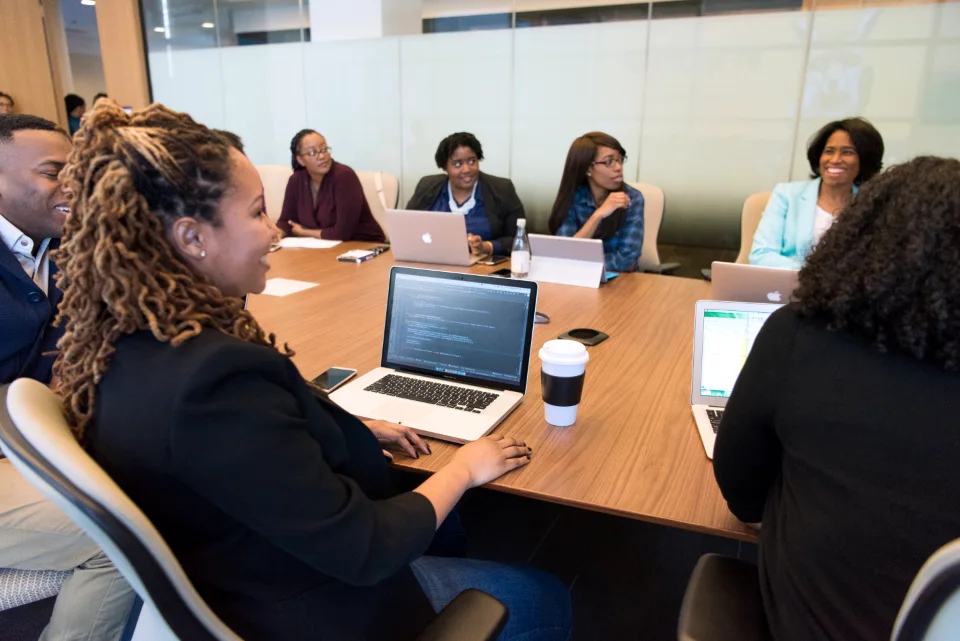Customer team reviewing accounts together around a meeting table